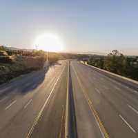 Empty ten lane route 118 freeway at sunrise in the San Fernando Valley area of Los Angeles, California.