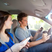Guy-and-girl-on-their-phones-while-driving[1]