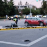 Accident of motorcycle and car at crossroad, blurred