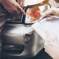 Insurance agent working during on site car accident claim proces