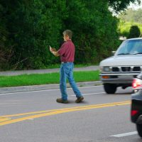 Jaywalking distracted cell phone user pedestrian