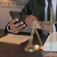 African Judge using Smartphone in Cour, Close Up