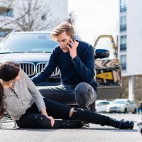 Worried young driver calling the ambulance after hitting acciden