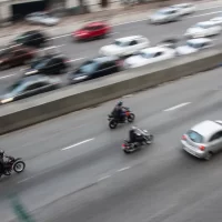 three-motorcyclists-ride-in-formation-on-a-busy-highway[1]